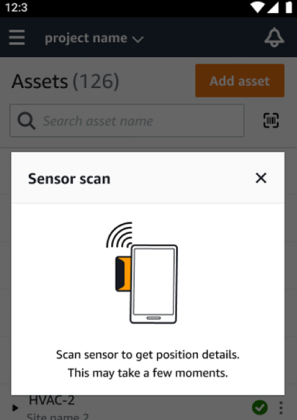 Cuadro de diálogo de escaneo del sensor que muestra el teléfono cerca del sensor con un texto de instrucciones debajo de la ilustración.