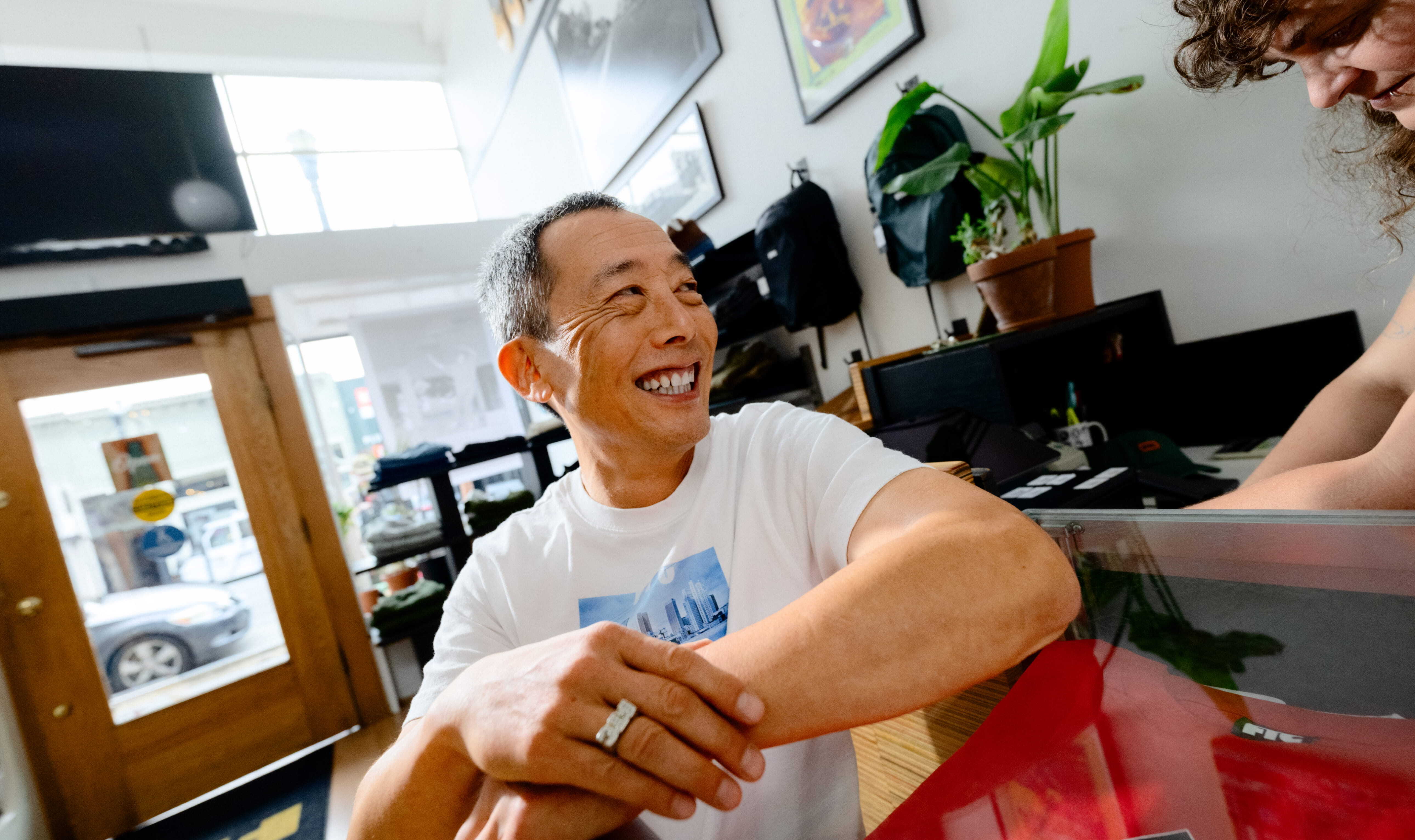 Smiling store owner at a retail counter