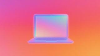 Soft-focus, glowing open laptop with iridescent hues on a gradient background