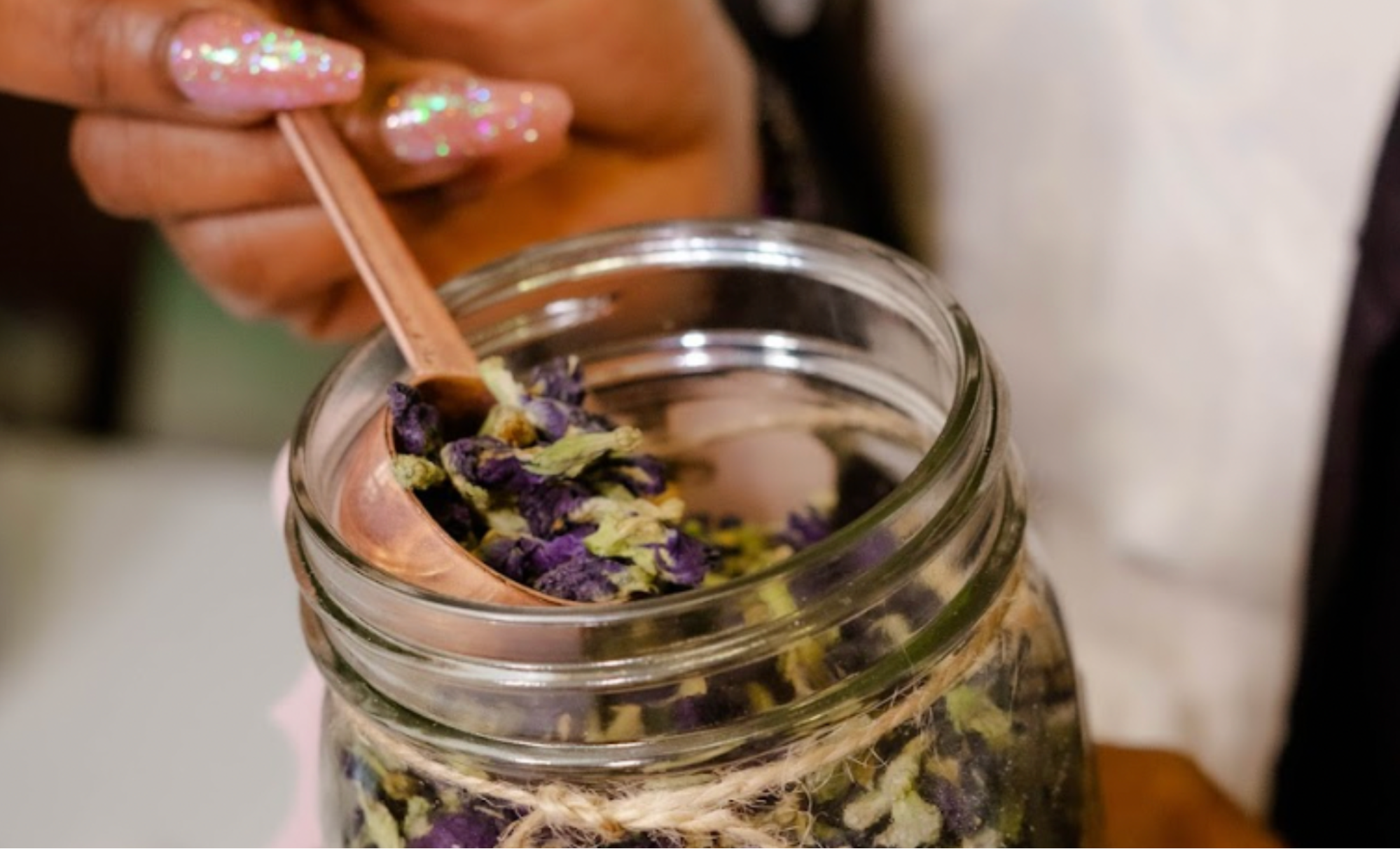 Dried tea scooped from a mason jar