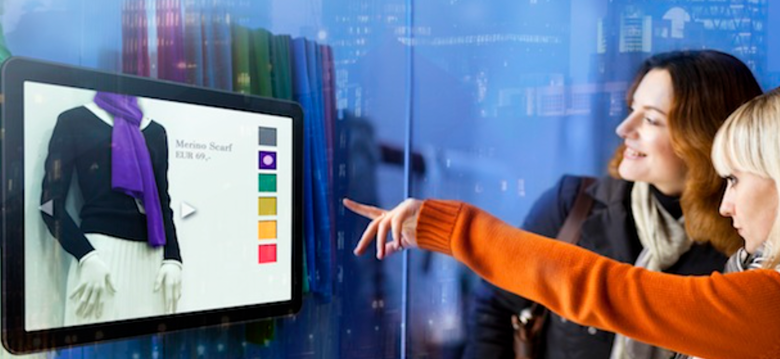 Two women looking and pointing at a computer screen